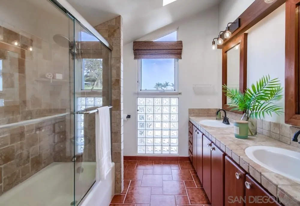 141 Sea Cliff Way Del Mar, CA 92014 - Photo 44 of 65 a bathroom with a granite countertop sink a mirror and a shower