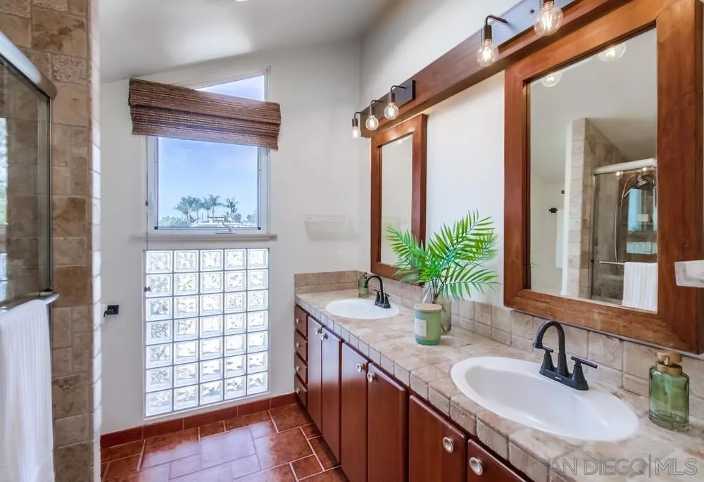141 Sea Cliff Way Del Mar, CA 92014 - Photo 46 of 65 a bathroom with a granite countertop sink a mirror and a shower