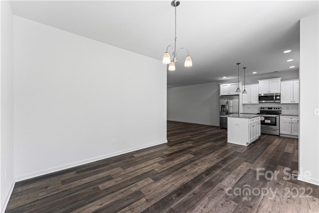 808 McDonald Road Charlotte, NC 28214 - Photo 12 of 30 a kitchen with stainless steel appliances granite countertop a refrigerator a stove and a wooden floors