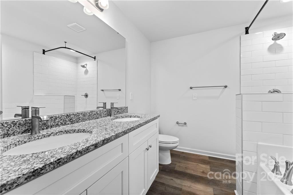 808 McDonald Road Charlotte, NC 28214 - Photo 25 of 30 a bathroom with a granite countertop sink toilet and shower