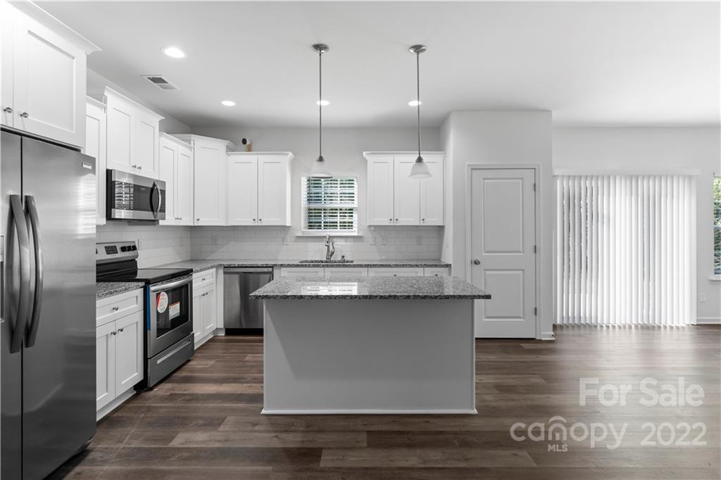 808 McDonald Road Charlotte, NC 28214 - Photo 5 of 30 a large kitchen with stainless steel appliances granite countertop a stove a sink and a refrigerator