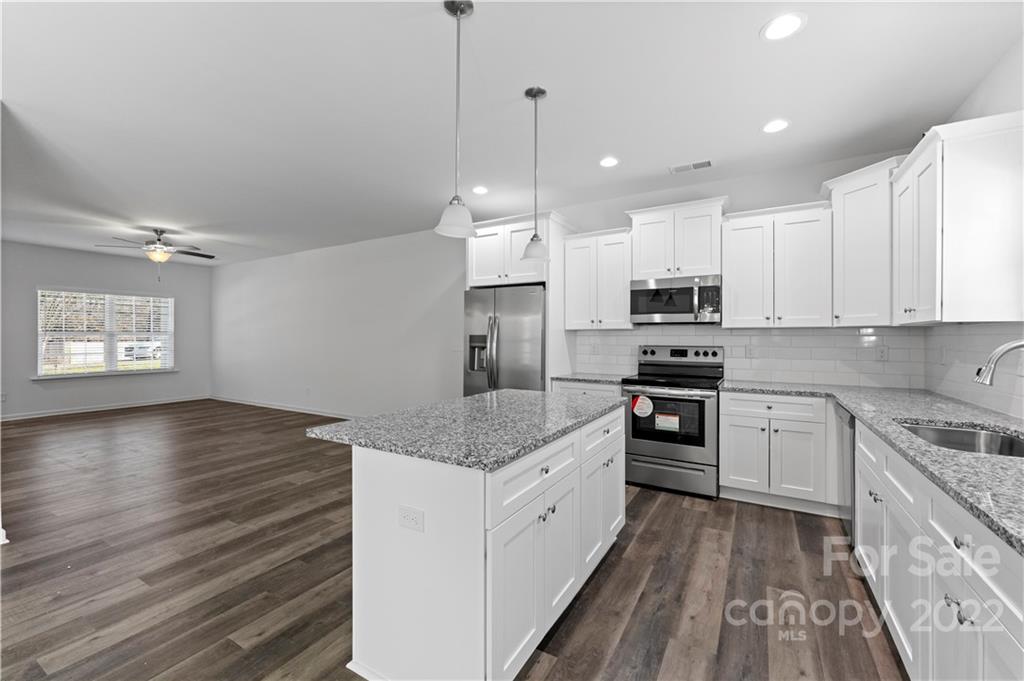 808 McDonald Road Charlotte, NC 28214 - Photo 8 of 30 a kitchen with stainless steel appliances granite countertop a stove sink and cabinets