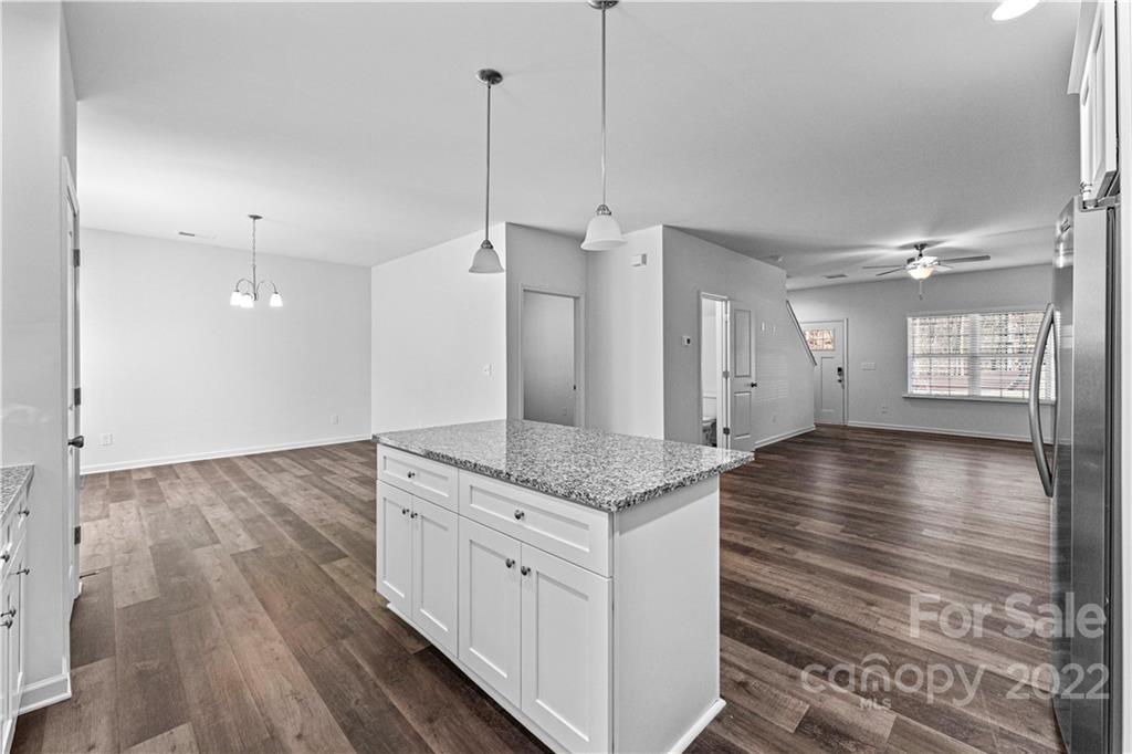 808 McDonald Road Charlotte, NC 28214 - Photo 9 of 30 a view of a kitchen island a stove and wooden floor