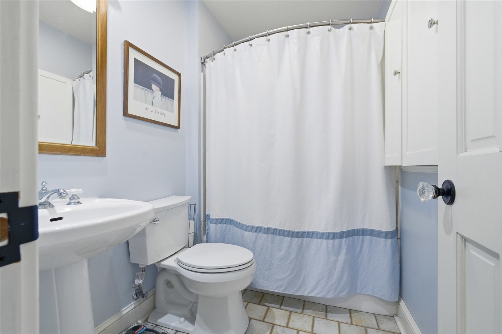 616 East Madison Street Pontiac, IL 61764 - Photo 20 of 37 a bathroom with a sink a toilet and shower curtain