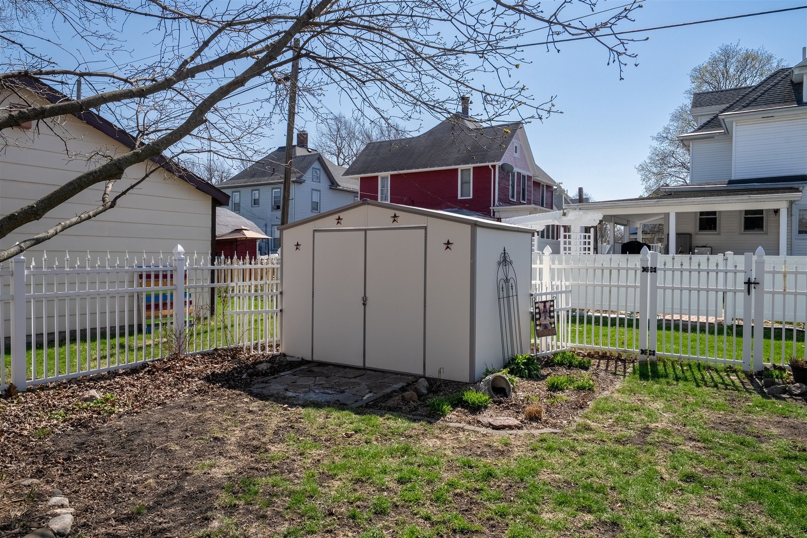 616 East Madison Street Pontiac, IL 61764 - Photo 28 of 37 a view of a house with a small yard and wooden fence