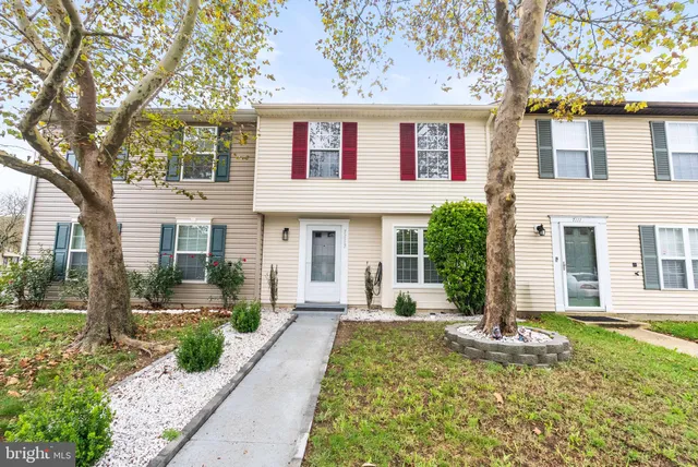 a front view of a house with a yard and fountain