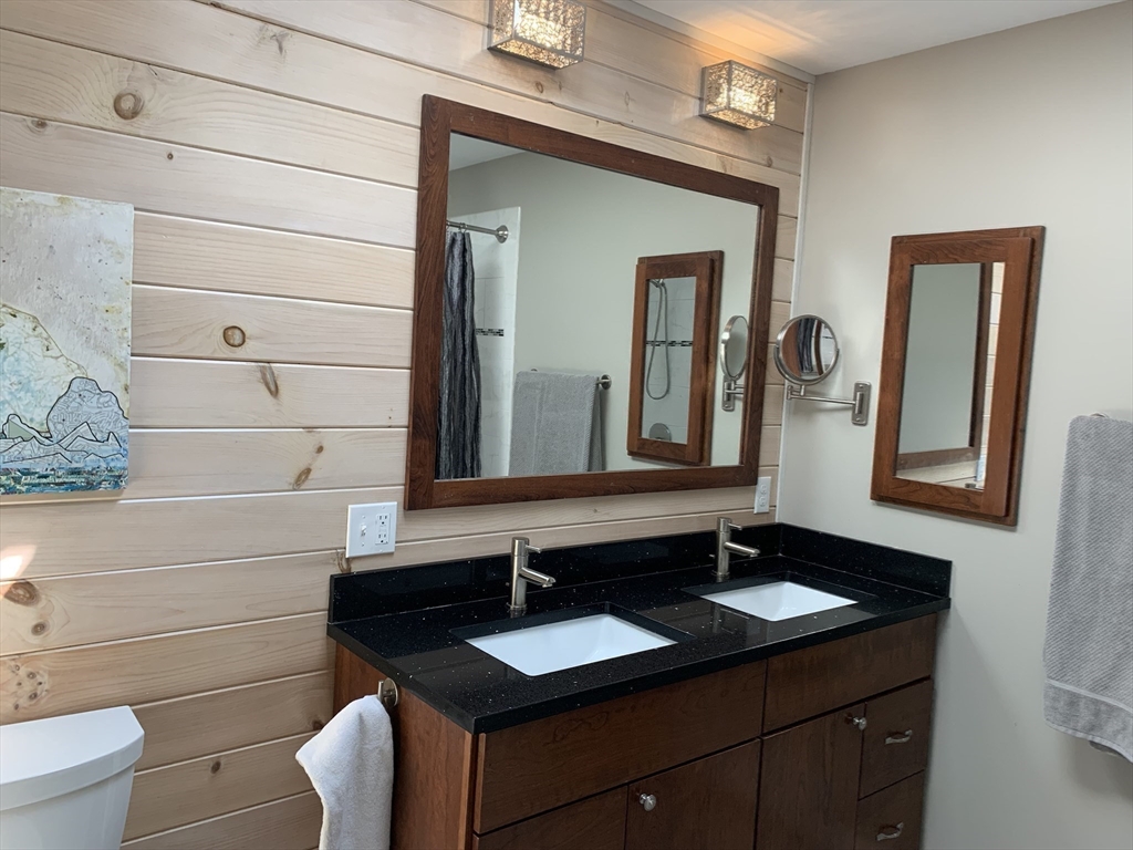 75 State Street Amherst, MA 01002 - Photo 25 of 39 a bathroom with a granite countertop sink and a mirror