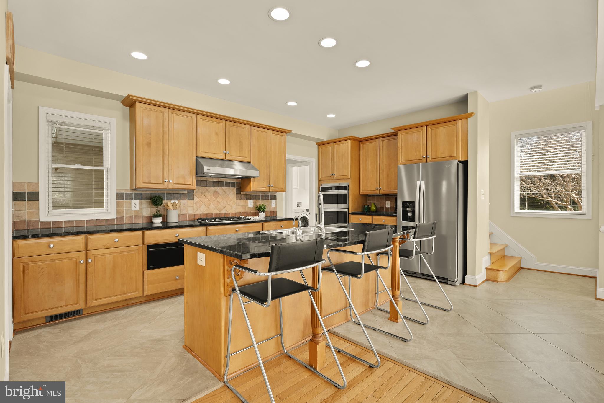 20407 Peach Tree Road Dickerson, MD 20842 - Photo 12 of 53 a kitchen with stainless steel appliances kitchen island granite countertop a refrigerator and cabinets