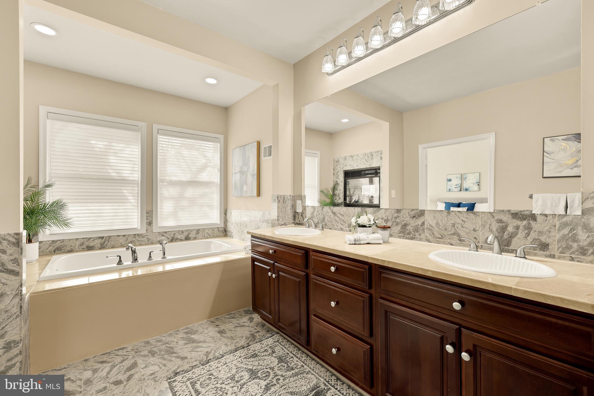 20407 Peach Tree Road Dickerson, MD 20842 - Photo 24 of 53 a bathroom with a tub sink and mirror