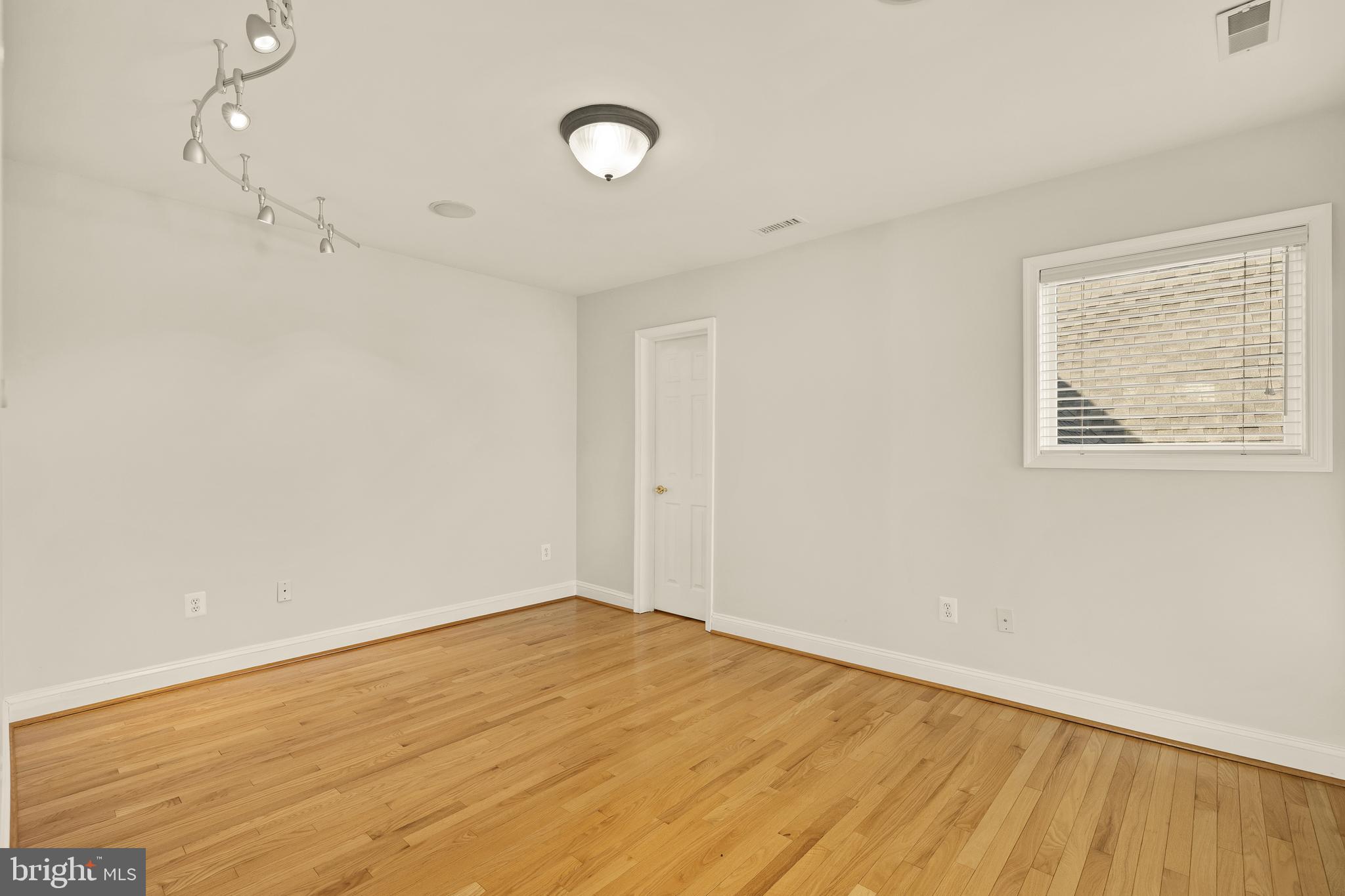 20407 Peach Tree Road Dickerson, MD 20842 - Photo 28 of 53 an empty room with wooden floor and windows