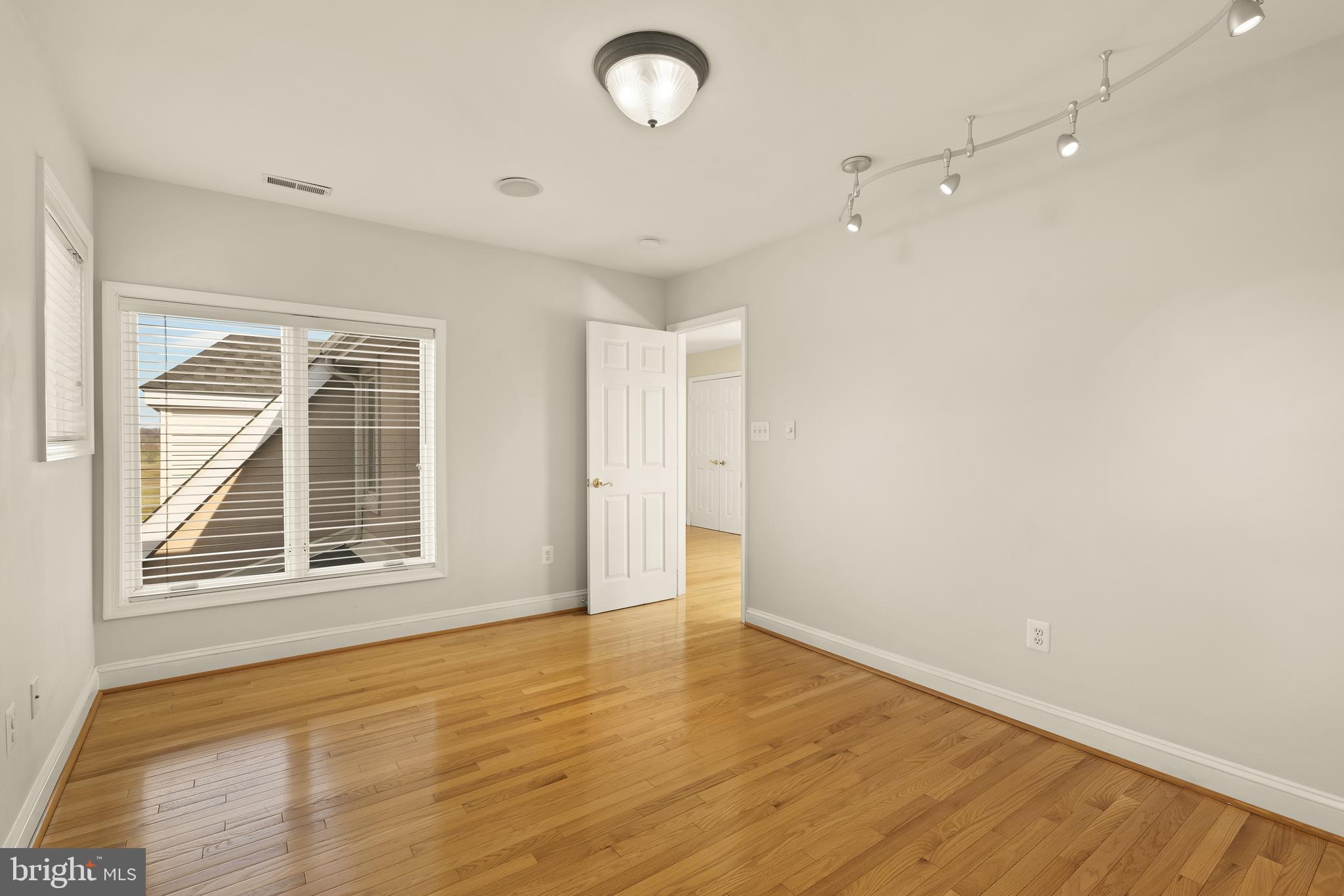 20407 Peach Tree Road Dickerson, MD 20842 - Photo 29 of 53 an empty room with wooden floor and windows