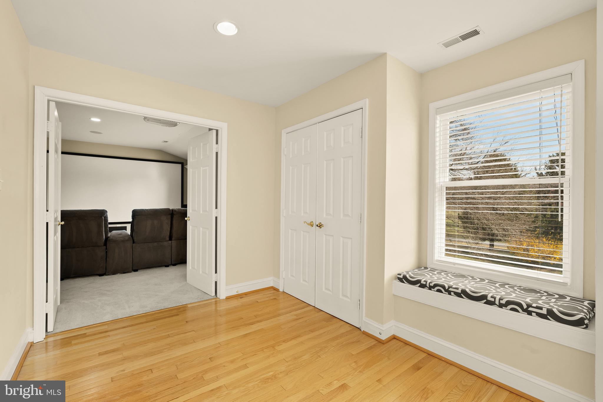 20407 Peach Tree Road Dickerson, MD 20842 - Photo 30 of 53 a bedroom with a bed and a large mirror next to a window