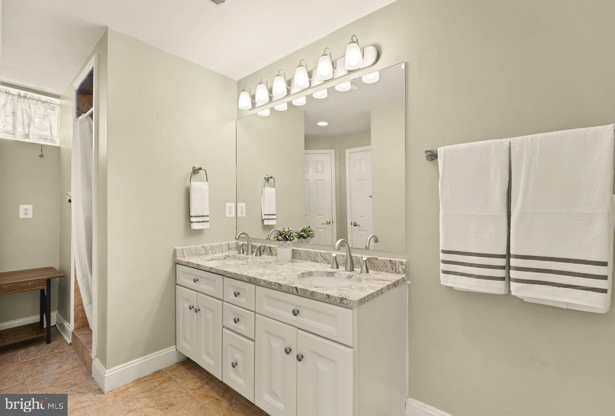 20407 Peach Tree Road Dickerson, MD 20842 - Photo 38 of 53 a bathroom with a double vanity sink and mirror