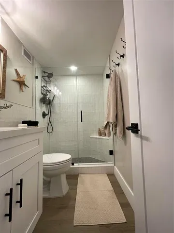 a bedroom with a bed and a night stand