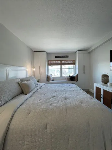 a view of a lake with boats and trees in the background
