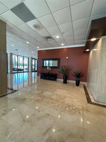 a view of parking garage with cars parked