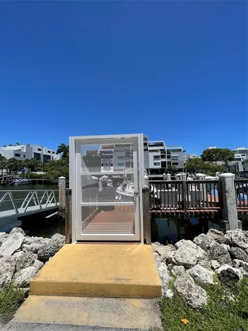 a view of a lake with boats and trees in the background