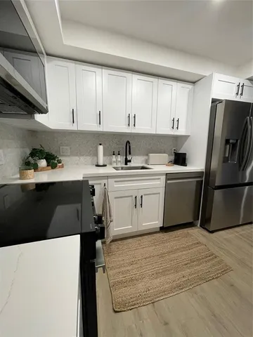 a kitchen with a sink a stove and refrigerator