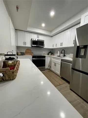 a kitchen with a sink a stove and cabinets