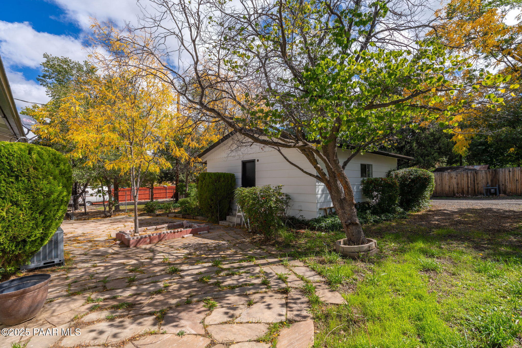 1213 Stetson Road Prescott, AZ 86303 - Photo 34 of 34 a backyard of a house with table and chairs a barbeque and a large tree