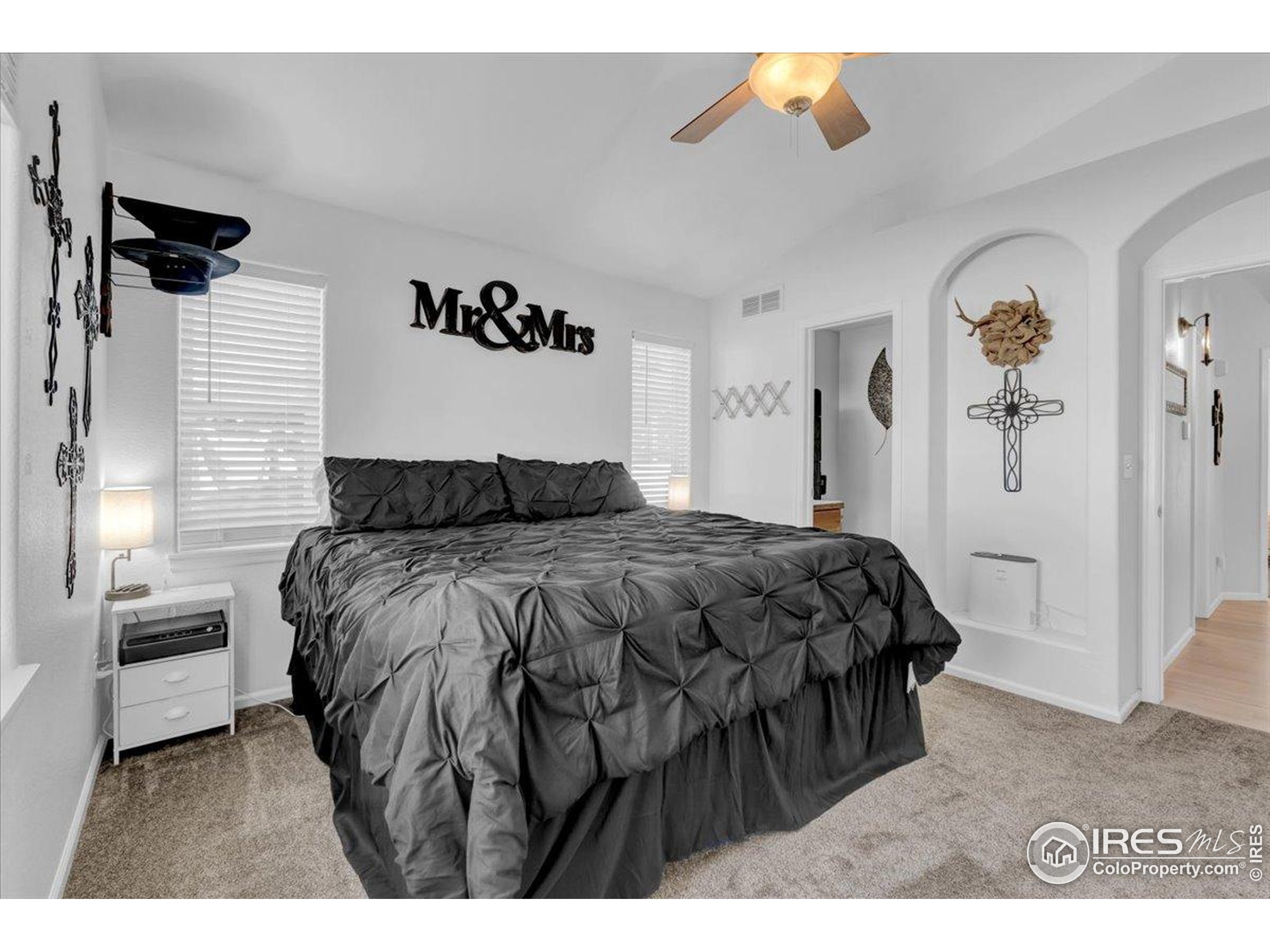 3411 Riesling Court Evans, CO 80634 - Photo 18 of 43 a bedroom with a bed and a walk in closet