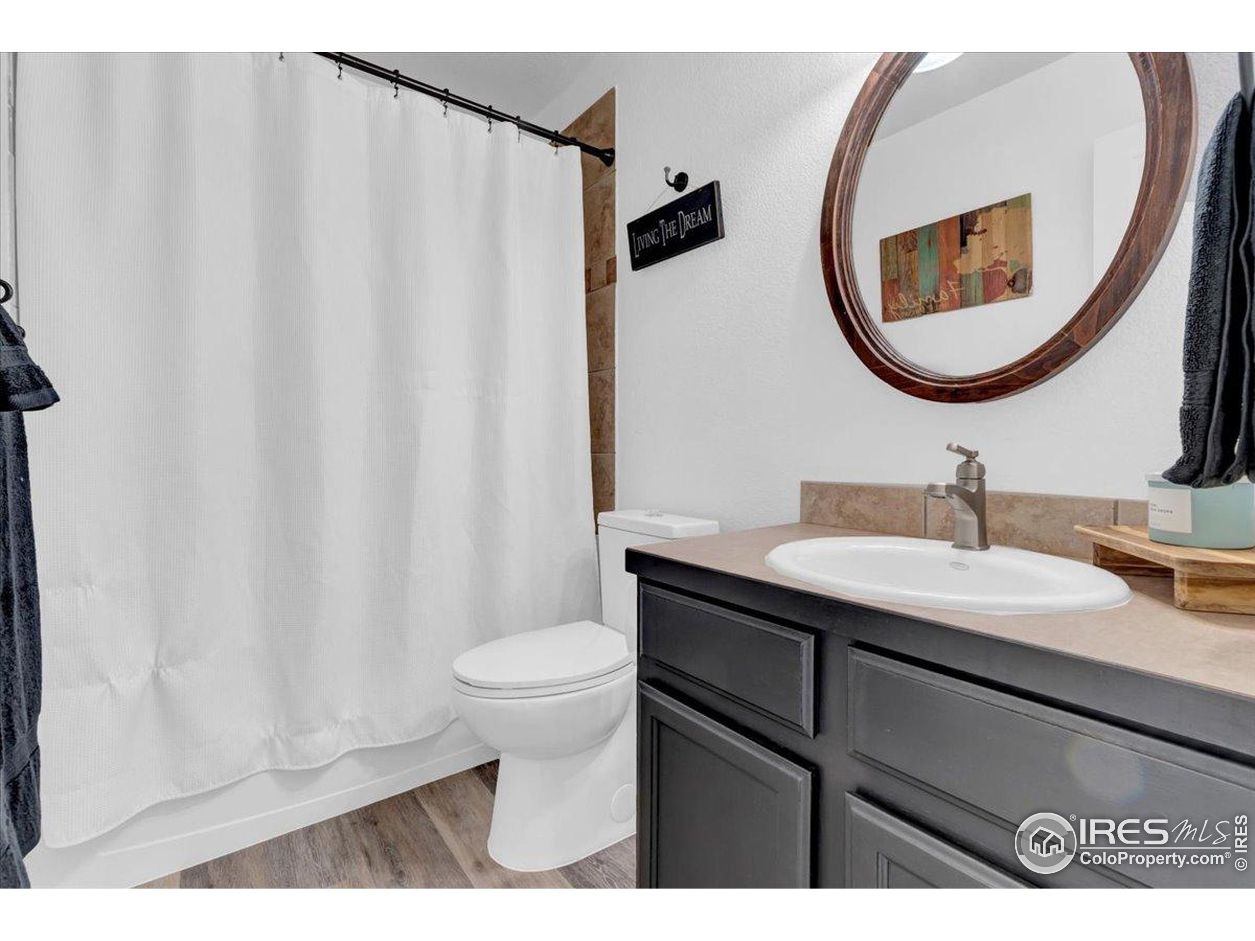 3411 Riesling Court Evans, CO 80634 - Photo 19 of 43 a bathroom with a sink and a mirror