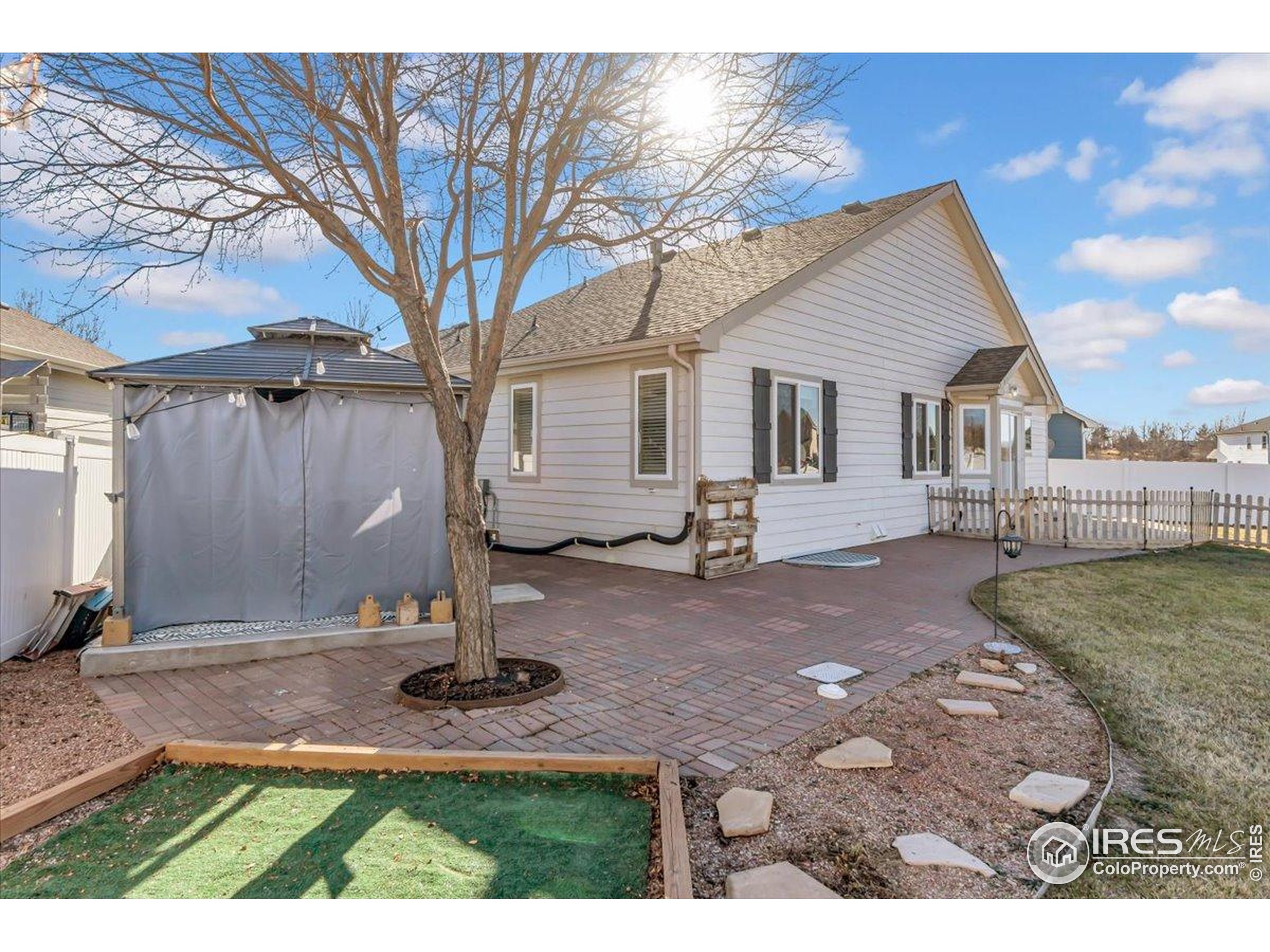 3411 Riesling Court Evans, CO 80634 - Photo 25 of 43 a backyard of a house with yard fire pit and outdoor seating