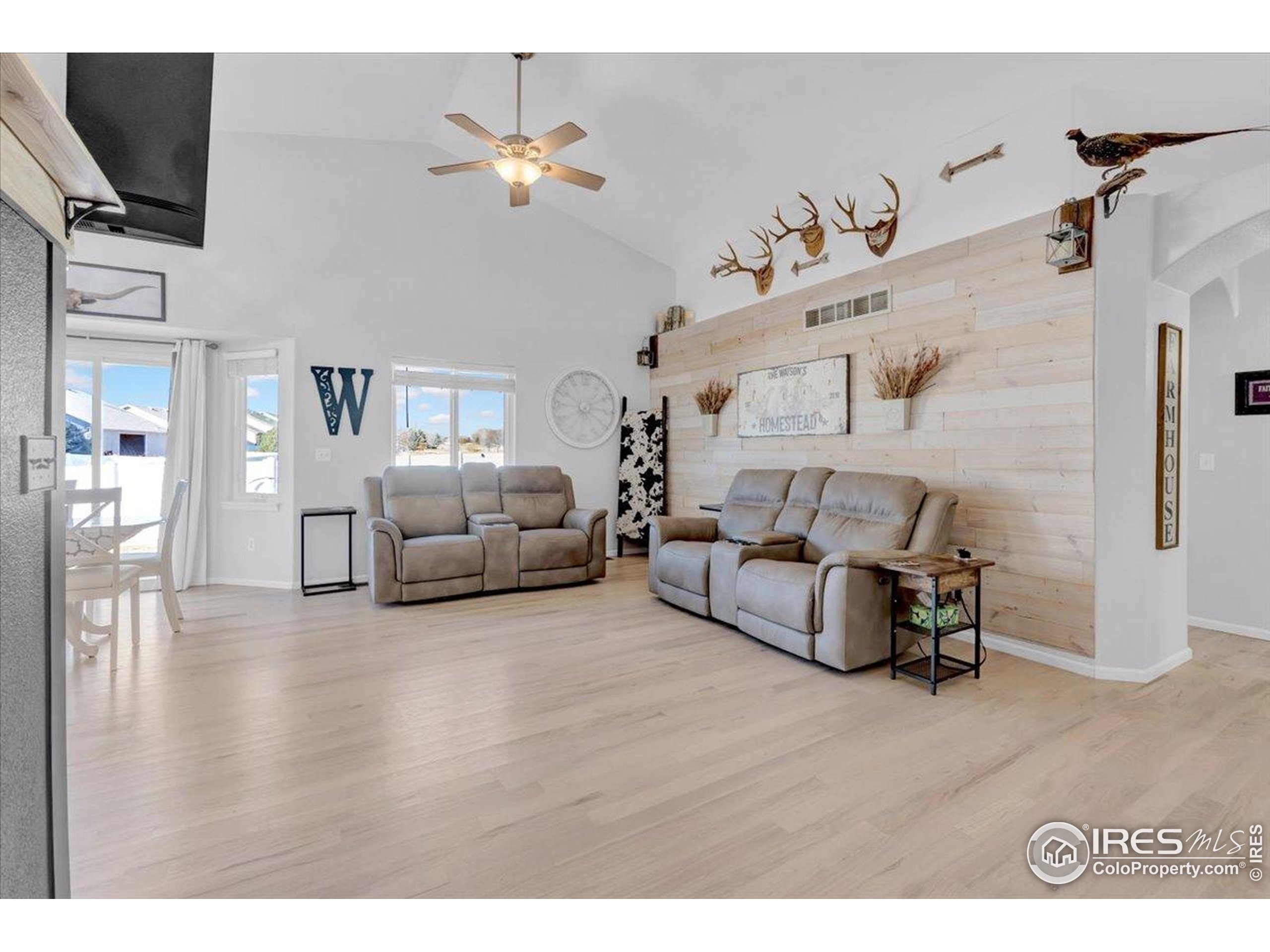 3411 Riesling Court Evans, CO 80634 - Photo 5 of 43 a living room with furniture and a flat screen tv