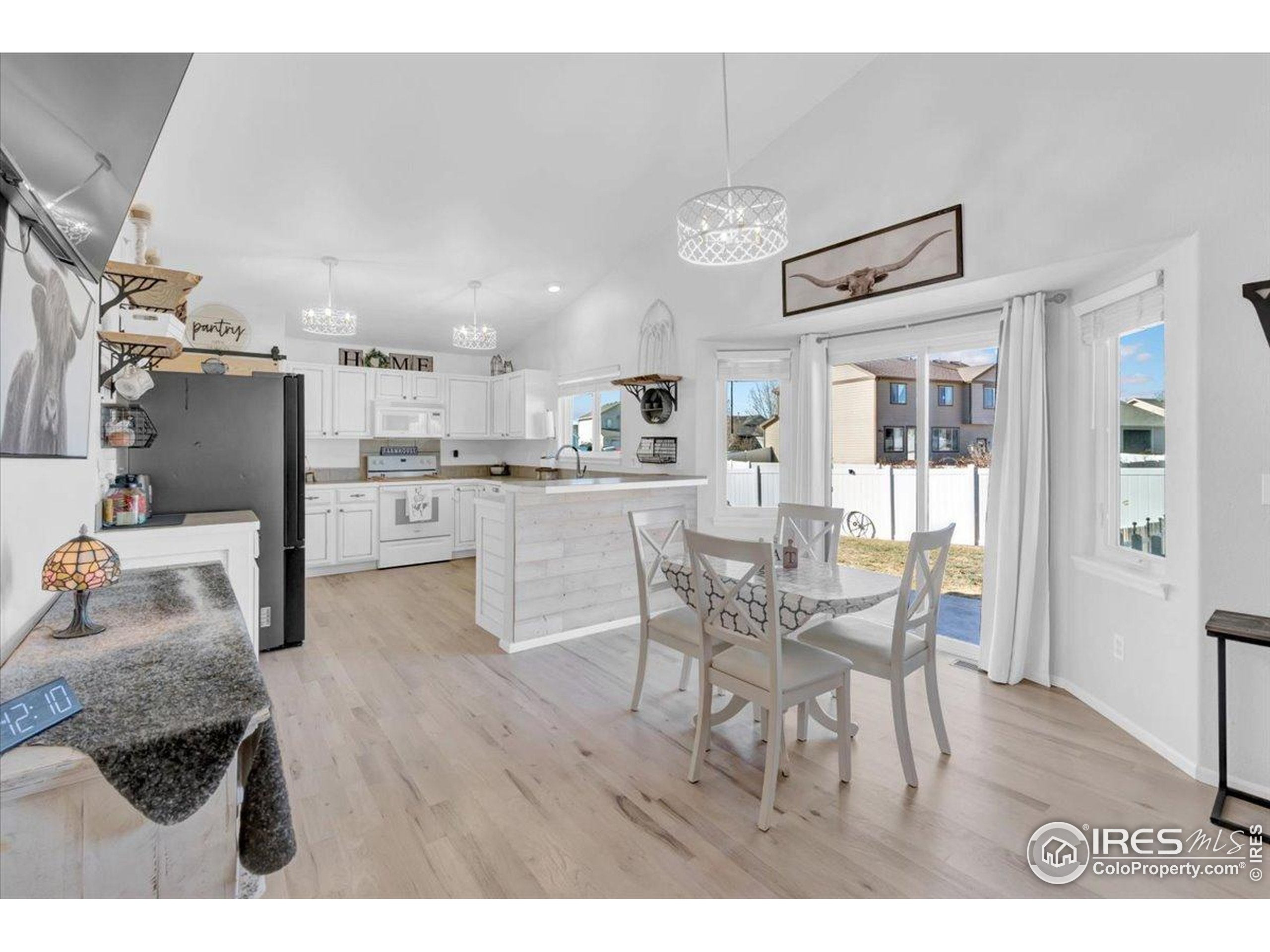 3411 Riesling Court Evans, CO 80634 - Photo 8 of 43 a living room with stainless steel appliances kitchen island granite countertop furniture and a kitchen view
