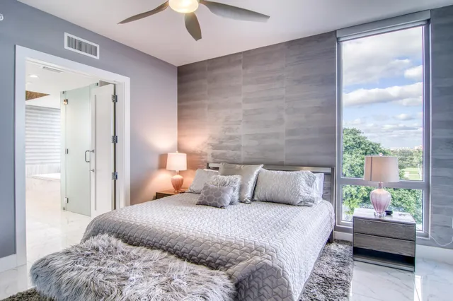 a bedroom with a large bed and a large window