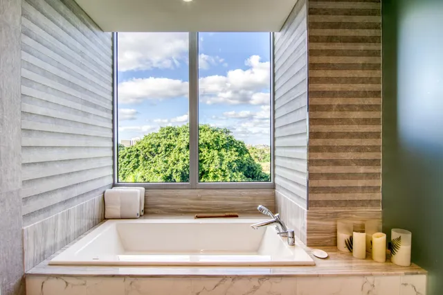 a bathroom with a bathtub and window