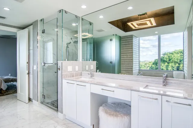 a bathroom with a granite countertop sink mirror and double