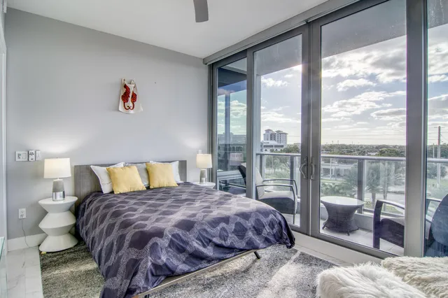 a bedroom with a large bed and a balcony view