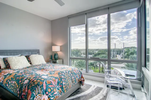 a bedroom with a bed and a large window