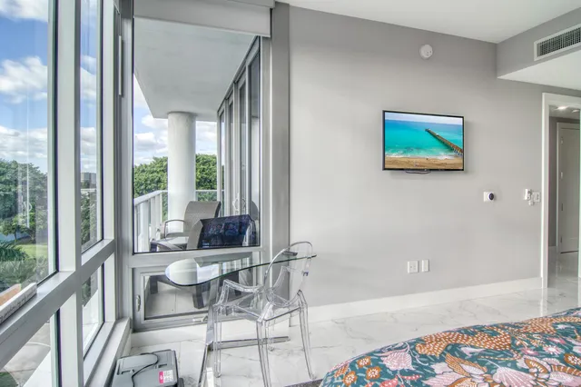 a living room with furniture and a floor to ceiling window
