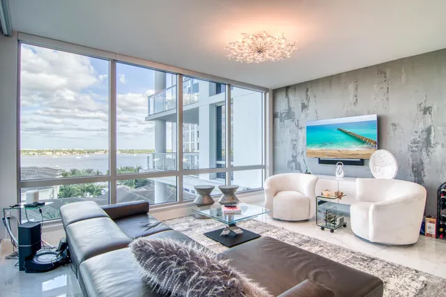 a living room with furniture and a floor to ceiling window