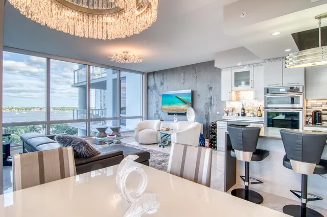 a living room with furniture fireplace and a large window