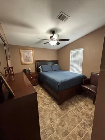 a bedroom with a bed and window