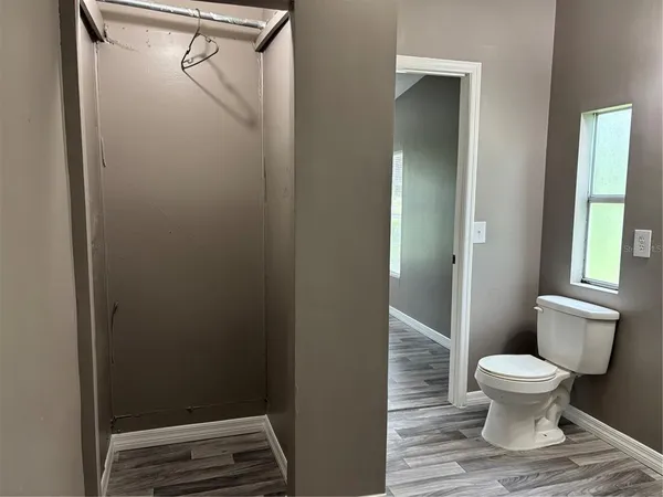 a bathroom with a toilet and a shower
