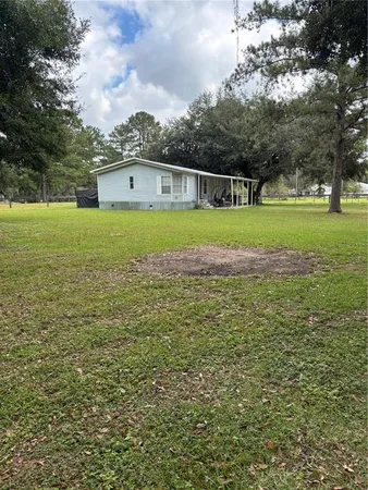 a front view of a house with a big yard