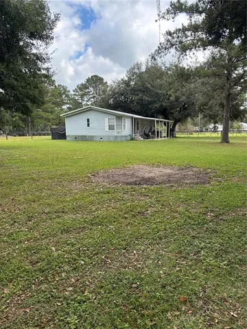 a front view of a house with a big yard
