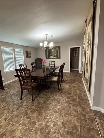 a dining room with furniture and window