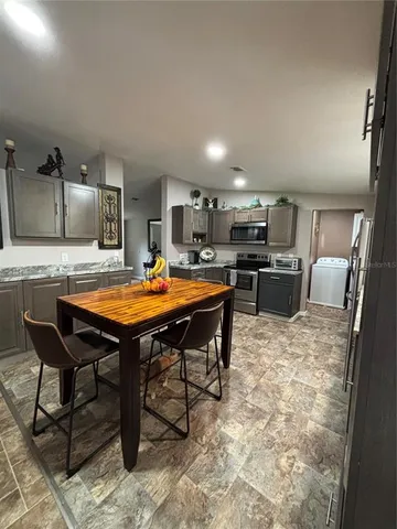 a kitchen with a table and chairs in it