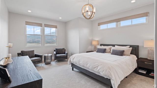355 East Overlook Loop Hideout, UT 84036 - Photo 15 of 40 Spacious Primary Suite featuring carpeting, high ceilings with recessed lighting, and a contemporary chandelier