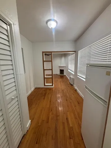a view of a room with wooden floor staircase and a kitchen