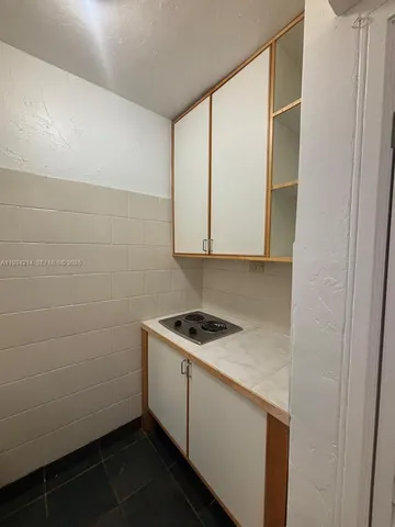 a bathroom with a sink and cabinets