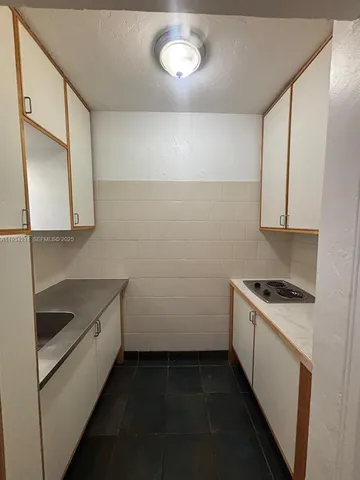 a kitchen with a stove and a sink