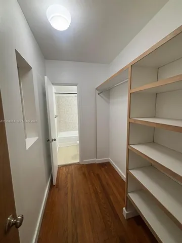 a view of a room with wooden floor and closet