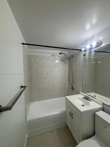 a bathroom with a sink a mirror and a bathtub