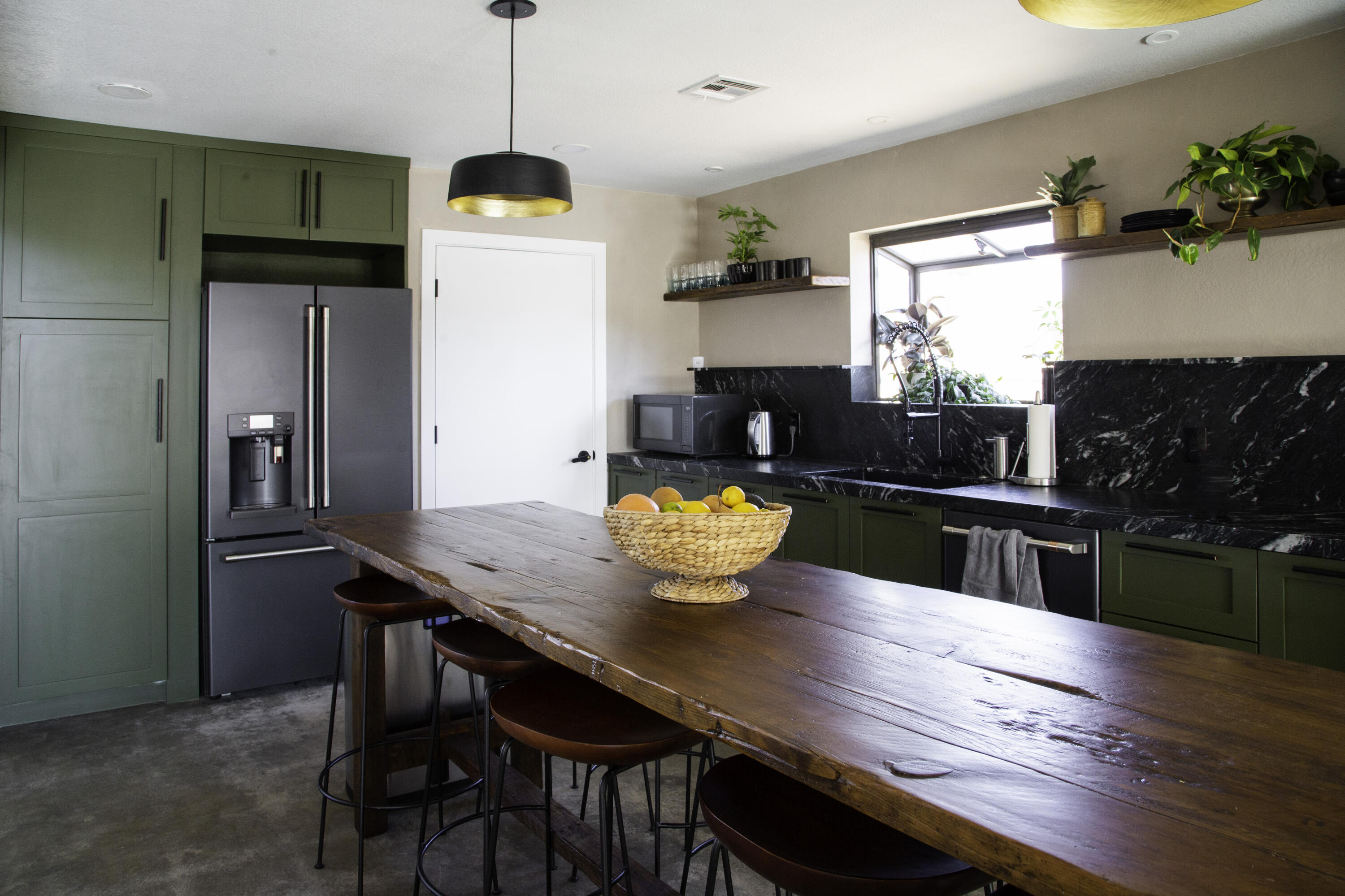 382 Cherokee Trail Yucca Valley, CA 92284 - Photo 20 of 66 a kitchen with stainless steel appliances granite countertop a table chairs and a wooden floor
